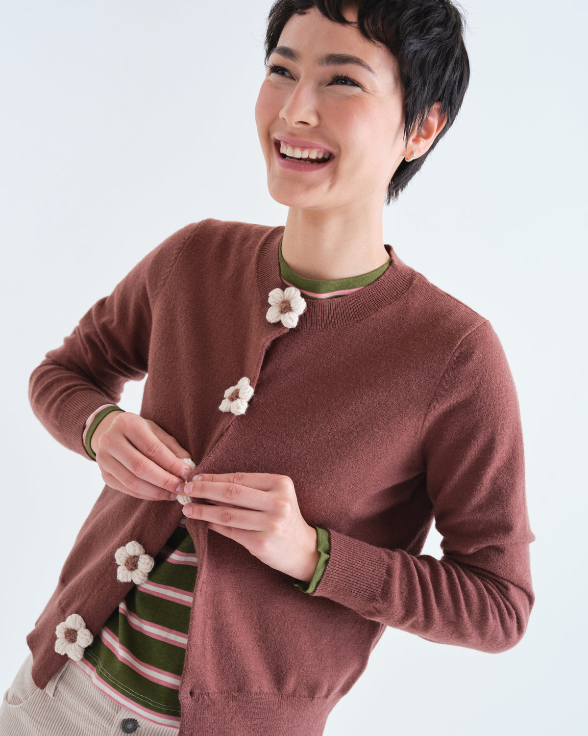 Détail du cardigan brun porté avec boutons fleuris
